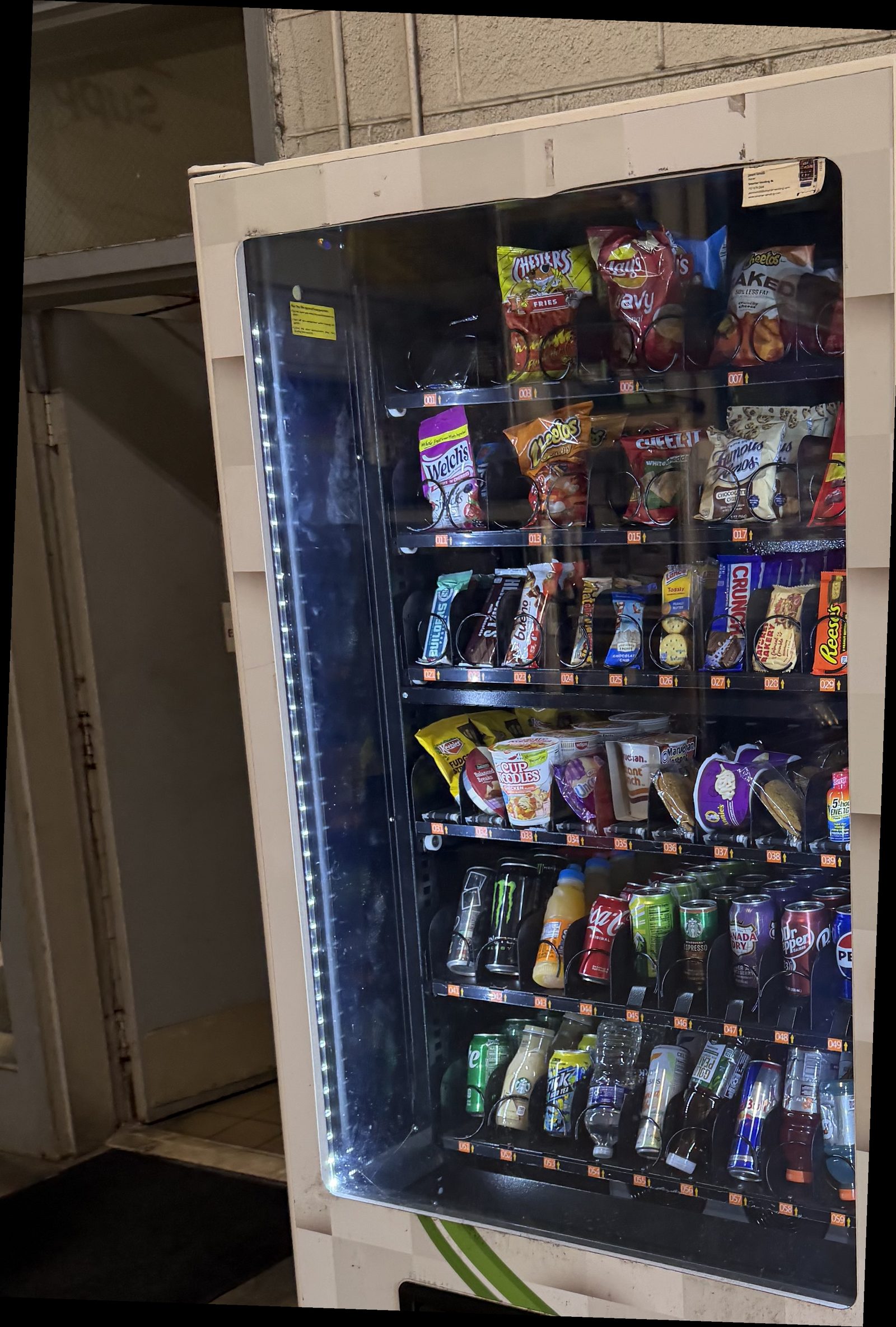 Blue Pearl vending machine stocked with snacks, candy, and drinks at a Hampton Roads warehouse location